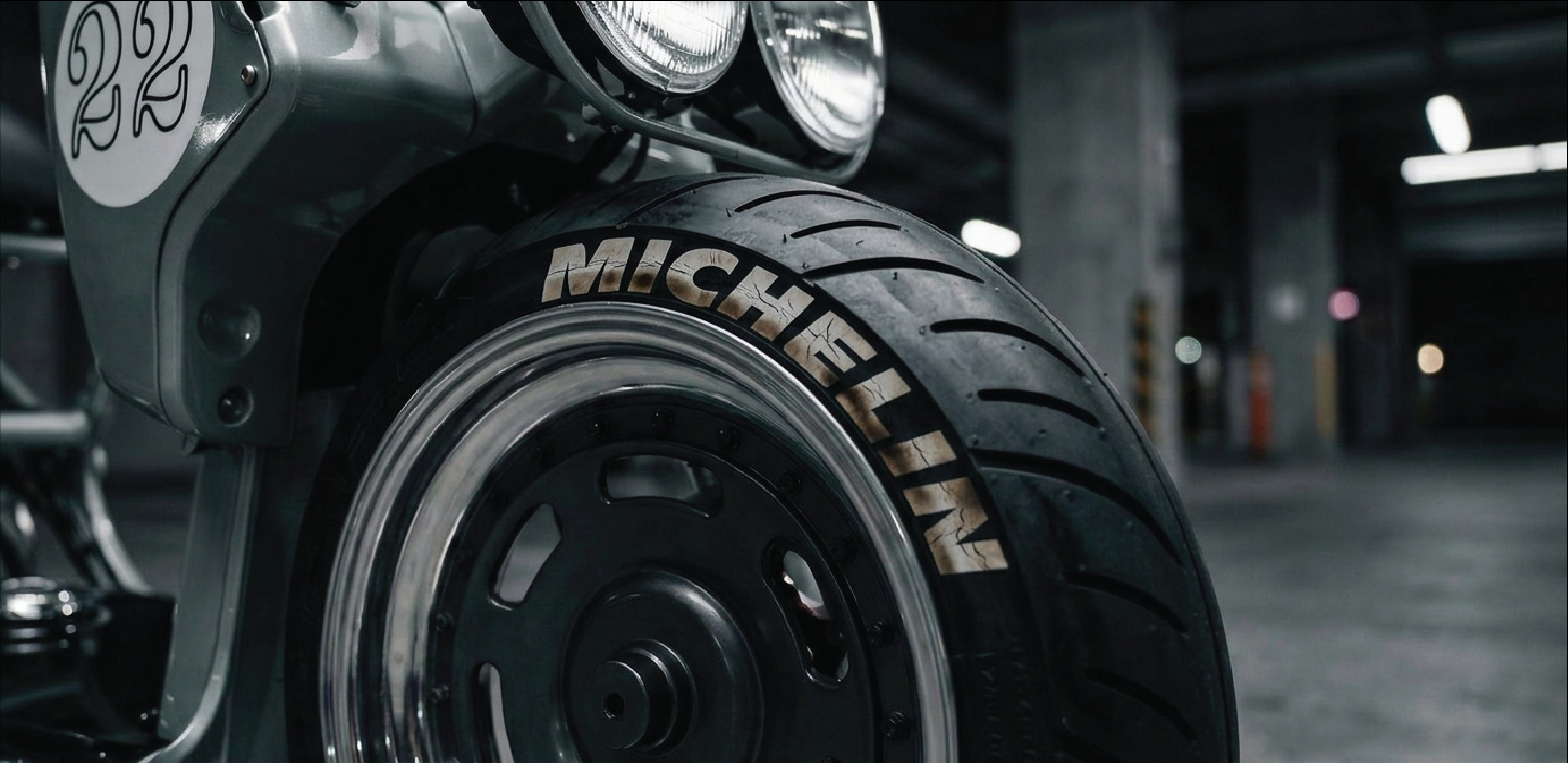fake Michelin tire on a motorcycle in a dark setting 